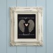 A framed sign with angel wings and a heart reads, “Your wings were ready but my heart was not,” displayed on a light blue paneled wall.