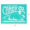 Turquoise sign with a white sketch of a rabbit. Text reads: “Honey Bunny Candy Co. Est. 1890. Cream Eggs, Chocolate Bunnies, Marshmallow Chicks, Jelly Beans.” Sign measures 24 by 18 inches.