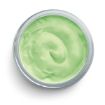 A small, round, clear container filled with smooth, light green cream viewed from above on a white background.