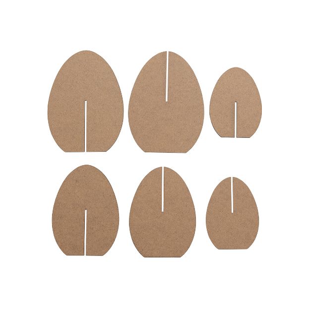 Six flat, oval-shaped pieces of brown cardboard with vertical slots, arranged in two rows on a white background; the slots are positioned differently on each piece.