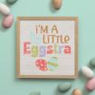 A frame with text on it next to eggs.