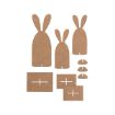 Laser-cut brown MDF pieces shaped like bunnies, rectangular bases, and small semi-circles, arranged on a white background for assembly into standing bunny figures.