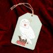 A wooden tag on red velvet features a white owl holding an envelope, standing on books labeled "Potions" and "Herbology." The tag has a twine loop for hanging.