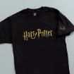 A black T-shirt featuring the "Harry Potter" logo in gold lettering across the chest and a small golden snake emblem on the sleeve.