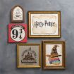 Five Harry Potter-themed framed wall art pieces: Hogwarts Express ticket, Platform 9¾ sign, "Harry Potter" text, a stack of books with the Sorting Hat, and a “Waiting for My Letter to Hogwarts” graphic, all on a gray wall.