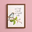 A framed illustration of a bird perched on a leafy branch, with the handwritten text "and I think to myself what a wonderful world" on a white background, against a pink wall.