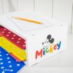 A white organizer decorated with a Mickey Mouse logo and colorful “Mickey” text holds red, yellow, and blue polka dot folders. On top are a notepad and a pencil. The Disney logo is in the lower left corner.