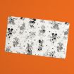 A white rectangular mat with black-and-white sketches of classic Disney characters, including Mickey Mouse, Minnie Mouse, Donald Duck, and Goofy, on an orange background.