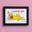 Framed illustration of a happy yellow cartoon dog with a red collar lying down, with the caption "I LOVE MY DOG (AND LIKE THREE PEOPLE)" on a white background against a pink wall.