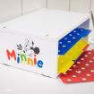 A white desk organizer featuring Minnie Mouse's face and colorful "Minnie" text, with three shelves holding blue, yellow, and red polka dot folders.
