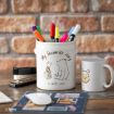 A desk with a white pen holder featuring Winnie the Pooh and Piglet, reading "My favourite story is with you," filled with colorful pens. Nearby are a stapler, a mouse, a mug with Pooh’s face, and a notebook.