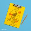 A yellow clipboard with an illustration of Woody from Toy Story, his name signed below, and playful icons like stars and a horseshoe. A pencil lies next to the clipboard on a light blue background.
