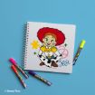 A spiral notebook with a cartoon drawing of Jessie from Toy Story on the cover, surrounded by colorful markers on a blue background. The name “Jessie” is written in blue on the cover.