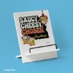A wooden stand displays a sign featuring three cartoon aliens from Disney/Pixar, reading "Saucy Cheesy Chosen Pizza Planet" in bold text on a blue background.