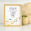 Framed sign with the text “Follow me and I will make you fishers of men. Matthew 4:19” above colorful illustrated fish, next to a small green succulent in a patterned pot on a white countertop.