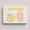 Illustration of a yellow ice cream tricycle with a striped yellow canopy, a front basket, and a pink cart that reads “Sunny with a chance of sprinkles,” against a light background.