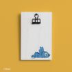 A small white wooden clipboard with a black clip displays a cute illustration of Stitch, the blue alien character from Disney, lying down in the lower right corner, set against a mustard yellow background.