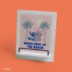 A decorative sign features Stitch, Angel, and Scrump sitting between two palm trees with a sun in the background. The text reads, "NAMA-STAY AT THE BEACH." The sign is set against an orange backdrop.