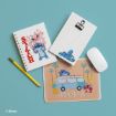 A flat lay of Disney Stitch-themed desk items: a spiral notebook with Stitch and Angel, a notepad with Stitch lying down, a "ALOHA" mouse pad with Stitch and a van, a pencil, a binder clip, and a white mouse on a blue background.