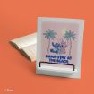A white book stand displays art of Stitch and Angel relaxing under palm trees with the text “NAMA-STAY AT THE BEACH.” An open book lies beside the stand on an orange background. Disney copyright is visible.