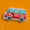 Illustration of a red van with "ROAD TRIP" written on the side, featuring cartoon characters and white flowers, driving against an orange background.