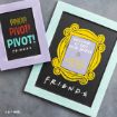 Two framed chalkboard signs referencing the TV show "Friends." One says "PIVOT! PIVOT! PIVOT!" and the other says "WELCOME TO THE REAL WORLD. IT SUCKS. YOU'RE GONNA LOVE IT!" Both have colorful borders and designs.