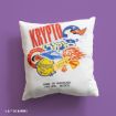 A white pillow with colorful superhero-themed designs, including the word "KRYPTO," animal illustrations, and the phrase "HOME IS WHEREVER YOU ARE... BUDDY." The pillow is set against a purple background.