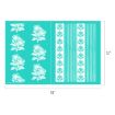 A turquoise sheet with white floral and striped patterns, measuring 18 inches wide by 12 inches tall. The left side has six large floral designs; the right side has repeating vertical floral and stripe motifs.