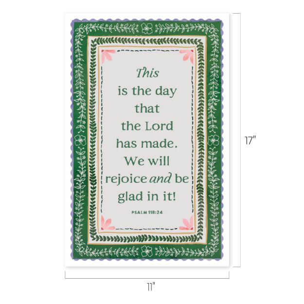 A decorative sign with a green floral border and scalloped edges displays the Bible verse: "This is the day that the Lord has made. We will rejoice and be glad in it! Psalm 118:24." Size: 17" x 11".