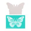 A plain, light wooden butterfly cutout is placed above a teal stencil featuring an intricate white butterfly design with floral and decorative patterns.