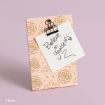 A notecard clipped to a pink, rose-patterned board displays the handwritten message "Believe in Yourself" with a heart and swirl, set against a light purple background. © Disney.
