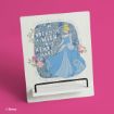 A decorative stand displays an illustration of Cinderella in a blue gown, surrounded by flowers. The text says, "Dream is a wish your heart makes." The background is pink. Disney copyright noted in the corner.