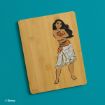 A bamboo cutting board features an illustration of Disney’s Moana standing with arms crossed, wearing her signature outfit, on a blue background. The Disney copyright is in the bottom left corner.