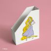 A white magazine file holder with an illustrated image of Rapunzel in a purple dress and long yellow hair, set against a pink background. © Disney.