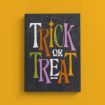 A black sign with the words “TRICK OR TREAT” in large, colorful letters—white, orange, green, and purple—against a yellow background. The sign has a weathered, cracked texture.