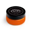 A round container of Chalk Couture Chalkology Paste with an orange base and a black lid, labeled “chalkology PASTE, CHALK COUTURE, WASHABLE PASTE,” on a white background.