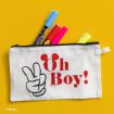 A white pencil case with a peace sign and red "Oh Boy!" text is unzipped, showing colorful highlighters and pens, on a yellow background.