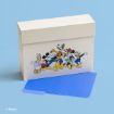 A box featuring Disney characters—Daisy, Mickey, Pluto, Goofy, Minnie, and Donald—stands on a blue surface with a blue file folder partially pulled out.