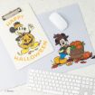 A clipboard and mouse pad with Halloween-themed Mickey Mouse designs are on a desk with a white keyboard and mouse. Mickey is dressed in fall attire with pumpkins and leaves, and the clipboard reads "Happy Halloween.