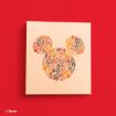 A beige canvas on a red wall features a Mickey Mouse head silhouette made of colorful autumn leaves in red, orange, yellow, and brown. Disney copyright is noted in the corner.