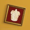 A gold-framed picture featuring the Gryffindor crest from Harry Potter on a red background, displayed against a yellow surface.
