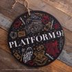 A round sign with "PLATFORM 9 3/4" in white, decorated with Harry Potter-themed doodles like a train, owl, suitcase, glasses, book, and Hogwarts crest on a rustic wood background.
