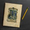 A spiral notebook with a Harry Potter illustration on the cover is next to a yellow pencil with a pink eraser, all placed on a dark surface.