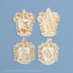 Four gold and white crests on a blue background, each representing a Hogwarts house: Ravenclaw (eagle), Gryffindor (lion), Slytherin (serpent), and Hufflepuff (badger).