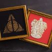 Two framed Harry Potter-themed artworks: one black with a gold Deathly Hallows symbol made of words, and one red with a gold Gryffindor crest. Both frames are ornate and gold.