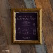 A framed "Midnight Margaritas" recipe print with bottle and lime sketches on a dark background, referencing "Practical Magic," hangs on rustic wooden planks.