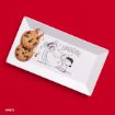 Two chocolate chip cookies on a rectangular plate with a Peanuts cartoon of Snoopy and Lucy laughing, on a bright red background.