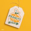 Wooden tag with a pumpkin graphic and “PEANUTS Pumpkin Patch! Pick Your Own!” text, featuring Snoopy, Woodstock, and a shovel, on a yellow background.