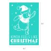 A teal illustration of Winnie the Pooh in a Santa hat dancing with snowflakes, text reads “KINDA FEELS LIKE CHRISTMAS.”.
