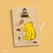 A wooden board with a drawing of Winnie the Pooh surrounded by autumn leaves, a metal clip at the top, and a piece of white chalk on a yellow background.